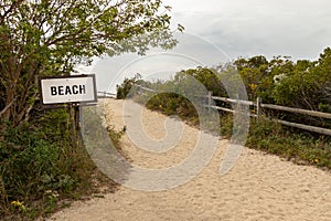Beach access sign next to the sandy trail to the beach, Cape May, New Jersey, USA