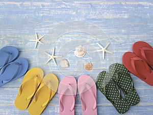 Beach accessories on blue wooden plank  summer holiday on the beach concept  colorful sandals with seashell and starfish