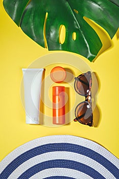 Beach accessories. Flat lay, natural cosmetics SPF for face, body. Summer Travel Vacation Concept. Sunscreen