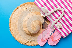 beach accessories flat lay top view on colored background Summer travel concept. Bag with starfish and sea shell. Top