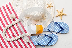 beach accessories flat lay top view on colored background Summer travel concept. Bag with starfish and sea shell. Top