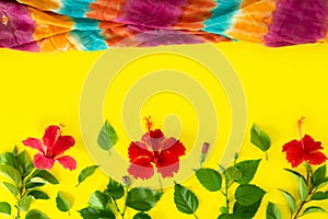 Beach accessories For the traveler on the yellow background - Colorful fabric and hibiscus flowers. Beach tourism concept. summer