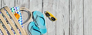 Beach accessories on wooden deck near outdoor swimming pool. Space for text