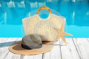 Beach accessories on wooden deck near swimming pool