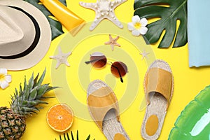 Beach accessories on yellow background