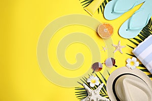 Beach accessories on yellow background. Space for text