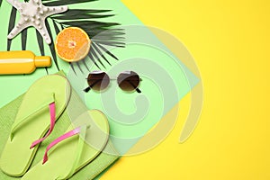 Beach accessories on yellow background. Space for text