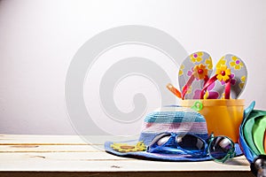 Beach accessory,hat,sunglasses,shoes,umbrella on wooden, concept