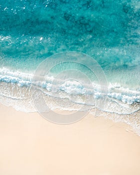 Beach aerial view. Nice top view of the blue ocean, crashing wave and white sand.