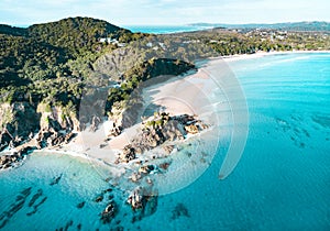 Beach aerial view. Nice top view of the blue ocean, crashing wave and white sand.