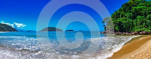 Beach in the afternoon. Prumirim Beach in Ubatuba, São Paulo, Brazil, on a sunny day with blue skies.