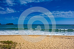 Beach in the afternoon. Prumirim Beach in Ubatuba, São Paulo, Brazil, on a sunny day with blue skies.