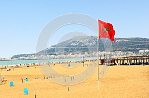 Beach in Agadir with flag of Morocco