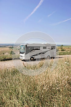 The beach and American style camping car parked on the Sussex Downs, England.