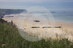 Beach of Arromanches with remains of Mulberry Harbour