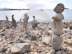 Beach art piles of rocks looking out over the bay at Playa Blanca Lanzarote