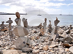 Beach art piles of rocks looking out over the bay at Playa Blanca Lanzarote