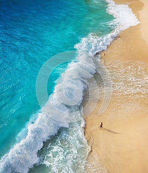 Beach as a background from top view. Waves and azure water as a background. Summer seascape from air. Bali island, Indonesia.