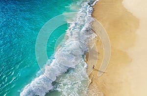 Beach as a background from top view. Waves and azure water as a background. Summer seascape from air. Bali island, Indonesia.