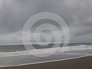 beach atmosphere with big water waves and cloudy skies