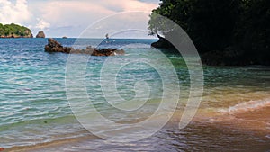 beach atmosphere with waves and coral on afternoon.