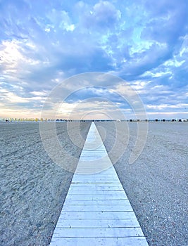 Beach background with a wood path in the middle of the sand