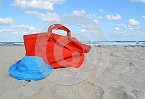 Beach Bag and Hat in the Ocean Sand