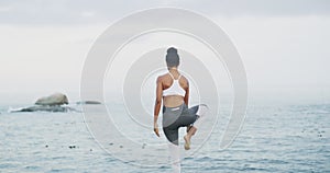 Beach, balance and woman doing a yoga exercise for calm mindset, energy and health. Nature, meditation and back of