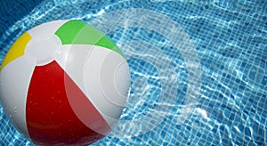 Beach ball floating in swimming pool