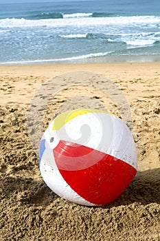 Beach ball in sand