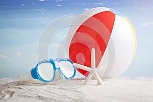 Beach ball and snorkel mask on the beach