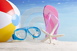 Beach ball and snorkel mask on the beach