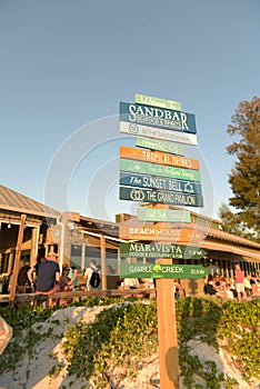 Beach bar sunset with direction signpost