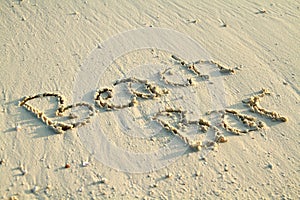 'Beach Bar' written in sand.