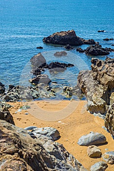 Beach bay rocky shore cove with blue ocean wave, Algarve