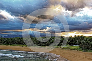 Beach bay with vast view to hilly country by storm clouds