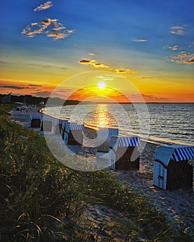 Beach with beach chairs and sunset on the Baltic Sea in Glowe. Mecklenburg-Vorpommern, Germany