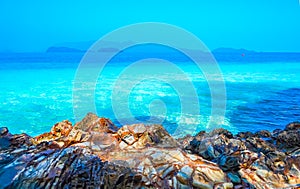 Beach, beautiful panoramic sea view, with clean water, blue sky and some brown rocks