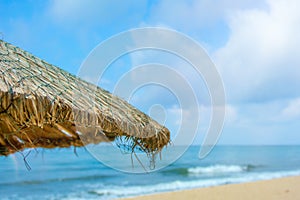 Beach beautiful thatched umbrellas and bright turquoise sea, great recreation and relaxation. tropical paradise.