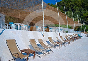 Beach beds at crystal sand of white marble