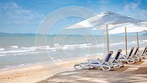 Beach bench under the umbrella on tropical island