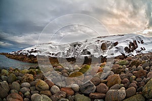 Beach with big round stones on the coast of the Barents Sea