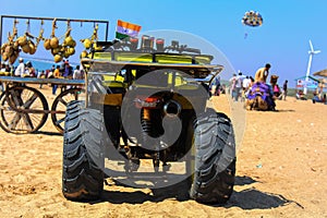 beach bike at mandvi Gujarat india ,four wheeler dirt bike on sand of sea beach during sunrise with dramatic colorful sky,