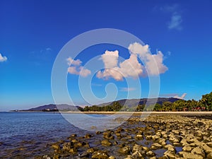 Beach on the Black Stone Malaysia. Clear blue water, sand and palm trees. Beautiful vacation spot, treatment and aquatics.