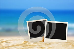 Beach with blank instant photos in front of summer sea background