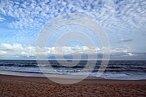 Beach and blue cloudy sky by the sea on sundown