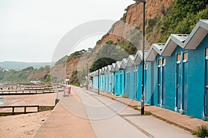 Beach with blue fish houses Huts and deck chairs at empty Shanklin Seafront, Isle of Wight. UK.