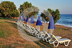 Beach with blue folded parasols
