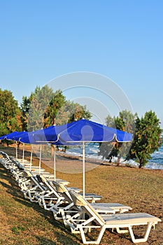 Beach with blue parasols