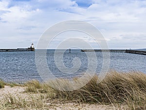 Beach at Blyth, Northumberland, UK with pier, lighthouse and copy space